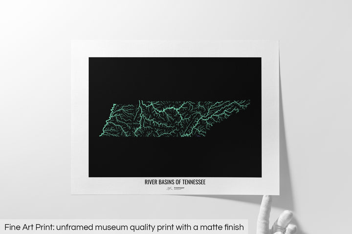 Unframed fine art print of a colourful map with a thick white mat. The title of the map and the Grasshopper Geography logo is printed on the mat, below the image. The map print lies flat on a white surface, a hand holding up one of the corners. The bottom text reads: Fine art print - unframed museum quality print with a matte finish.
