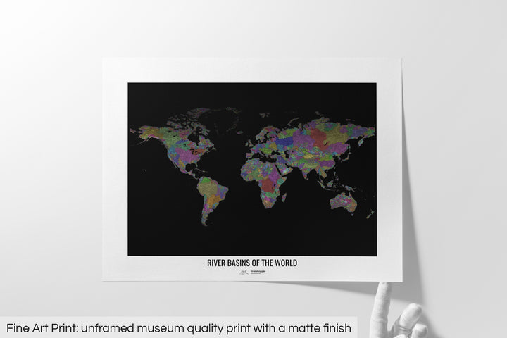Unframed fine art print of a colourful map with a thick white mat. The title of the map and the Grasshopper Geography logo is printed on the mat, below the image. The map print lies flat on a white surface, a hand holding up one of the corners. The bottom text reads: Fine art print - unframed museum quality print with a matte finish.