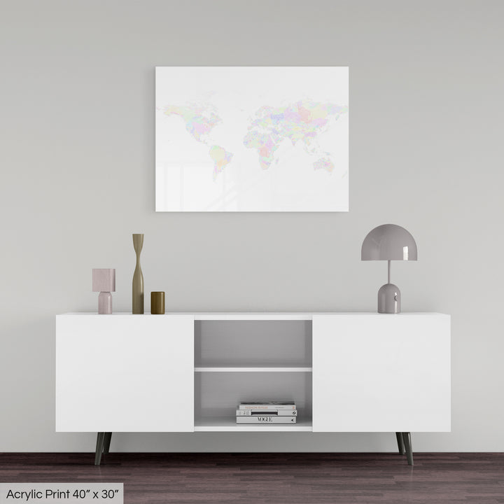 A colourful Grasshopper Geography map, home decor hanging on a grey wall in a living room. The map is printed on an acrylic panel and hangs above a modern low storage cabinet.
