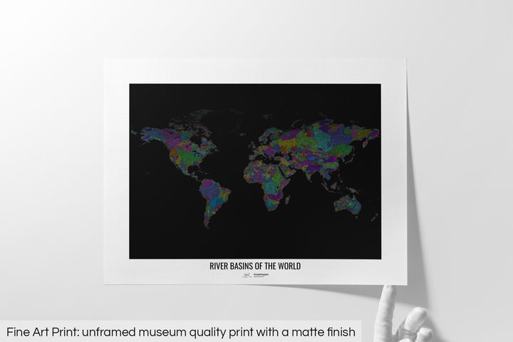 Unframed fine art print of a colourful map with a thick white mat. The title of the map and the Grasshopper Geography logo is printed on the mat, below the image. The map print lies flat on a white surface, a hand holding up one of the corners. The bottom text reads: Fine art print - unframed museum quality print with a matte finish.