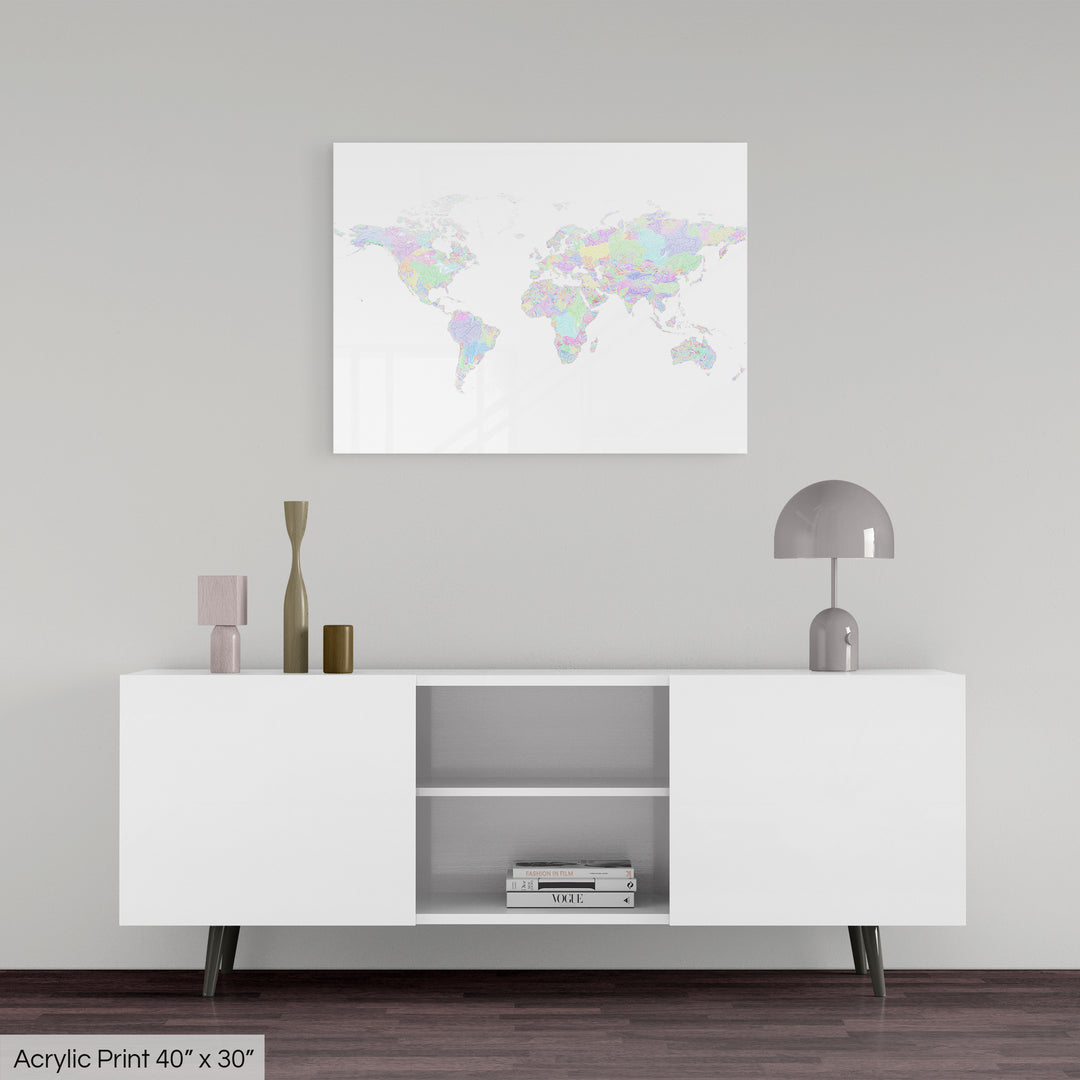 A colourful Grasshopper Geography map, home decor hanging on a grey wall in a living room. The map is printed on an acrylic panel and hangs above a modern low storage cabinet.