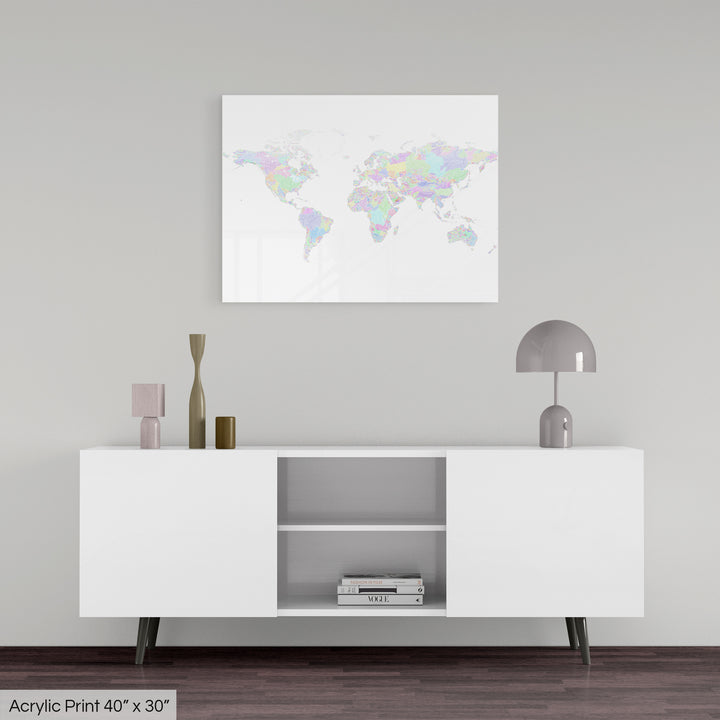 A colourful Grasshopper Geography map, home decor hanging on a grey wall in a living room. The map is printed on an acrylic panel and hangs above a modern low storage cabinet.