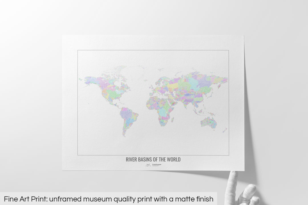 Unframed fine art print of a colourful map with a thick white mat. The title of the map and the Grasshopper Geography logo is printed on the mat, below the image. The map print lies flat on a white surface, a hand holding up one of the corners. The bottom text reads: Fine art print - unframed museum quality print with a matte finish.