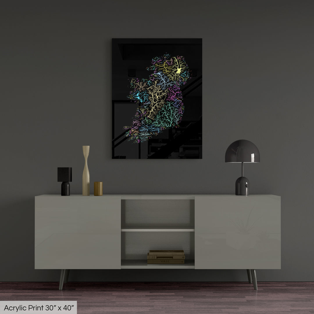 A colourful Grasshopper Geography map, home decor hanging on a grey wall in a living room. The map is printed on an acrylic panel and hangs above a modern low storage cabinet.