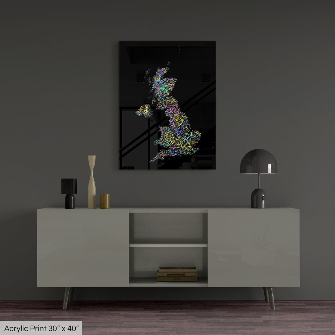 A colourful Grasshopper Geography map, home decor hanging on a grey wall in a living room. The map is printed on an acrylic panel and hangs above a modern low storage cabinet.