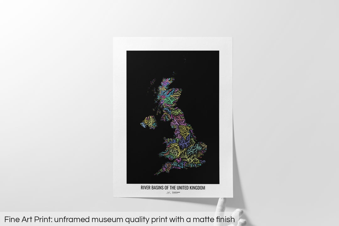 Unframed fine art print of a colourful map with a thick white mat. The title of the map and the Grasshopper Geography logo is printed on the mat, below the image. The map print lies flat on a white surface, a hand holding up one of the corners. The bottom text reads: Fine art print - unframed museum quality print with a matte finish.