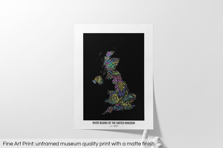 Unframed fine art print of a colourful map with a thick white mat. The title of the map and the Grasshopper Geography logo is printed on the mat, below the image. The map print lies flat on a white surface, a hand holding up one of the corners. The bottom text reads: Fine art print - unframed museum quality print with a matte finish.