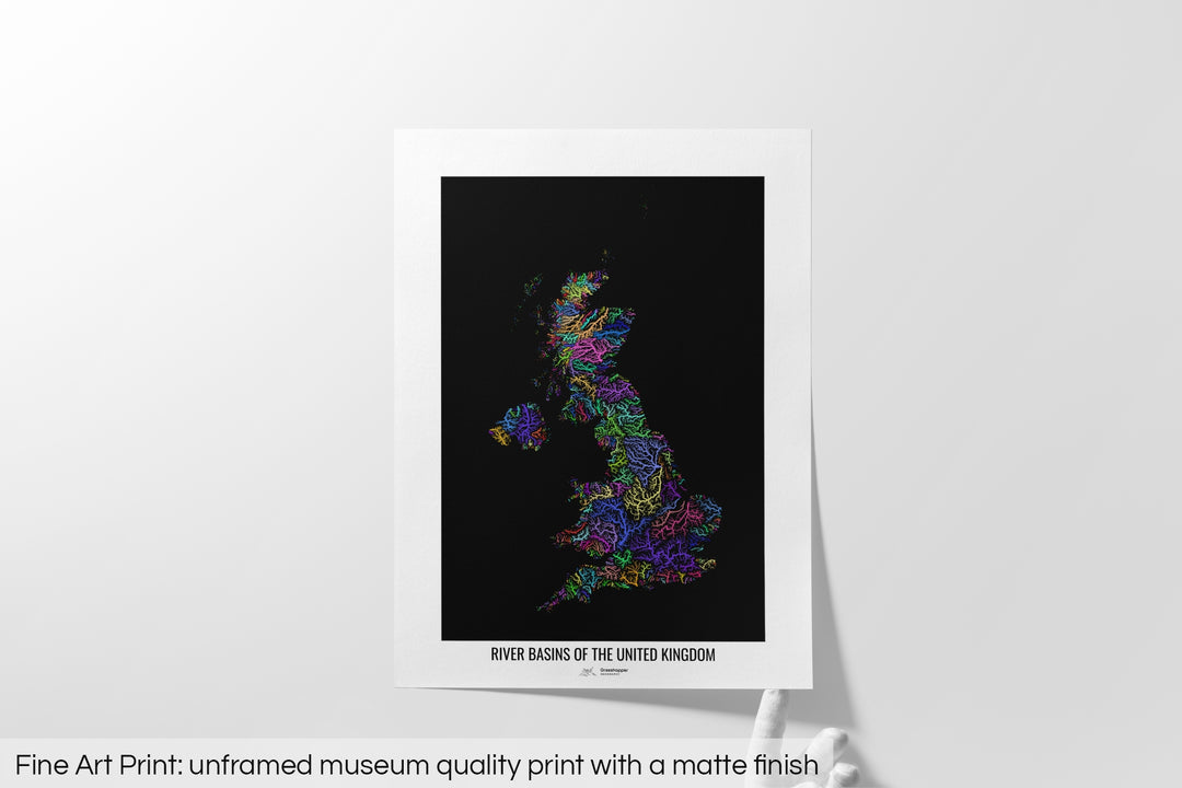 Unframed fine art print of a colourful map with a thick white mat. The title of the map and the Grasshopper Geography logo is printed on the mat, below the image. The map print lies flat on a white surface, a hand holding up one of the corners. The bottom text reads: Fine art print - unframed museum quality print with a matte finish.