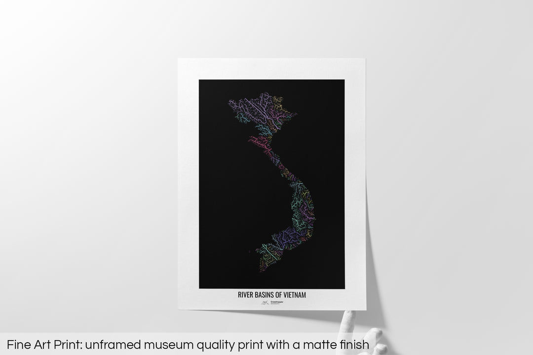 Unframed fine art print of a colourful map with a thick white mat. The title of the map and the Grasshopper Geography logo is printed on the mat, below the image. The map print lies flat on a white surface, a hand holding up one of the corners. The bottom text reads: Fine art print - unframed museum quality print with a matte finish.