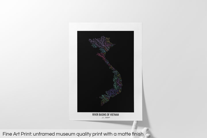 Unframed fine art print of a colourful map with a thick white mat. The title of the map and the Grasshopper Geography logo is printed on the mat, below the image. The map print lies flat on a white surface, a hand holding up one of the corners. The bottom text reads: Fine art print - unframed museum quality print with a matte finish.