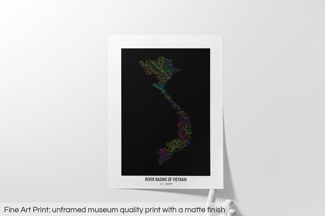Unframed fine art print of a colourful map with a thick white mat. The title of the map and the Grasshopper Geography logo is printed on the mat, below the image. The map print lies flat on a white surface, a hand holding up one of the corners. The bottom text reads: Fine art print - unframed museum quality print with a matte finish.