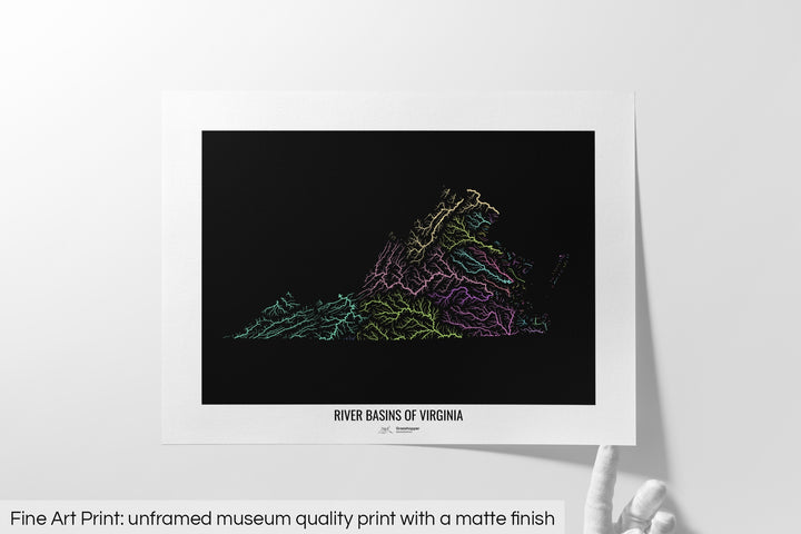 Unframed fine art print of a colourful map with a thick white mat. The title of the map and the Grasshopper Geography logo is printed on the mat, below the image. The map print lies flat on a white surface, a hand holding up one of the corners. The bottom text reads: Fine art print - unframed museum quality print with a matte finish.