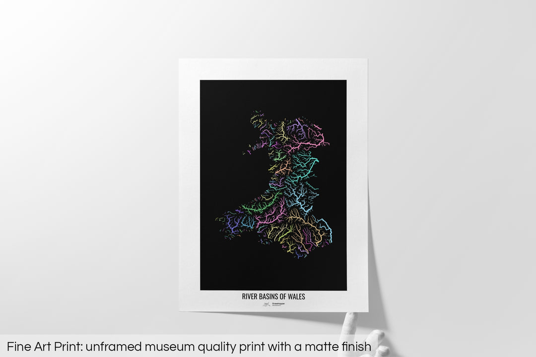 Unframed fine art print of a colourful map with a thick white mat. The title of the map and the Grasshopper Geography logo is printed on the mat, below the image. The map print lies flat on a white surface, a hand holding up one of the corners. The bottom text reads: Fine art print - unframed museum quality print with a matte finish.