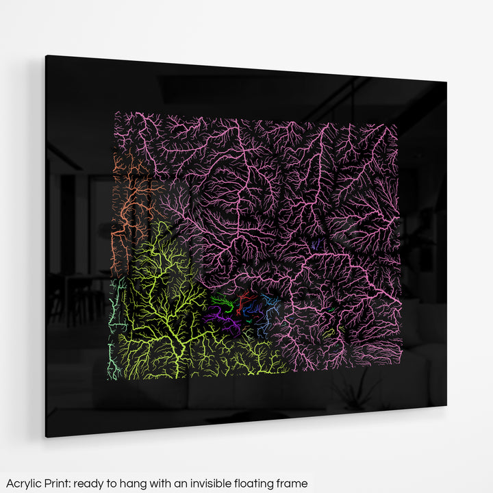 A colourful Grasshopper Geography map hanging on a white wall. The text at the bottom reads: Acrylic print - ready to hang with an invisible floating frame.
