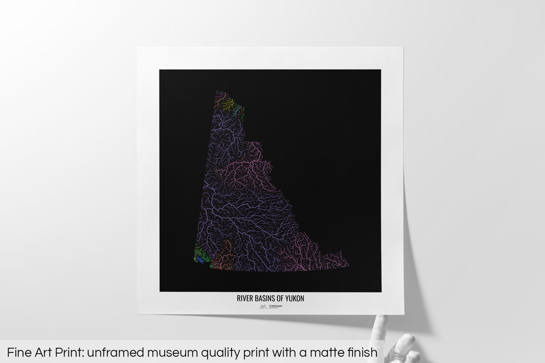 Unframed fine art print of a colourful map with a thick white mat. The title of the map and the Grasshopper Geography logo is printed on the mat, below the image. The map print lies flat on a white surface, a hand holding up one of the corners. The bottom text reads: Fine art print - unframed museum quality print with a matte finish.