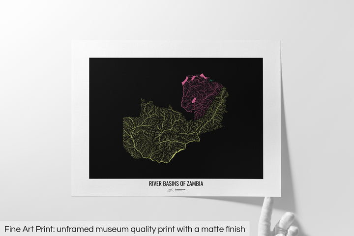 Unframed fine art print of a colourful map with a thick white mat. The title of the map and the Grasshopper Geography logo is printed on the mat, below the image. The map print lies flat on a white surface, a hand holding up one of the corners. The bottom text reads: Fine art print - unframed museum quality print with a matte finish.