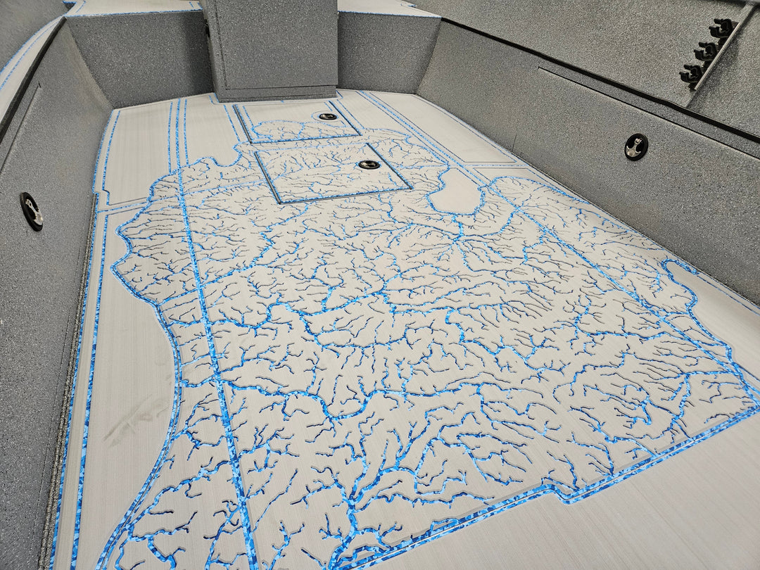 The custom made deck of a boat with the river basin map of Michigan engraved into it.