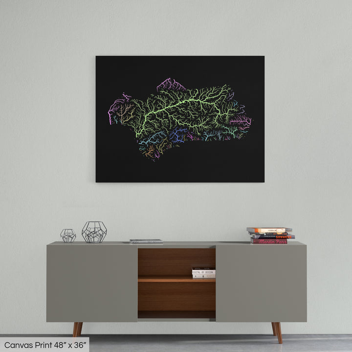 A colourful Grasshopper Geography map home decor in a living room, on a light grey wall. The map is printed on canvas and hangs above a modern low storage cabinet.