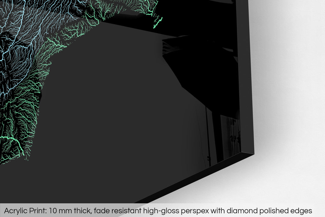 Closeup of an acrylic panel's corner, the details of a Grasshopper Geography map is visible. The text at the bottom reads: Acrylic print - 10 mm thick, fade reistant high-gloss perspex with diamond polished edges.