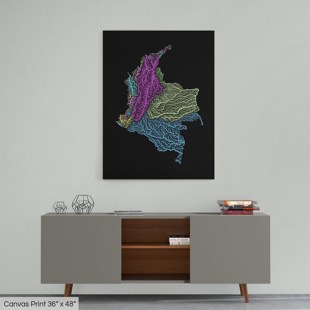 A colourful Grasshopper Geography map home decor in a living room, on a light grey wall. The map is printed on canvas and hangs above a modern low storage cabinet.