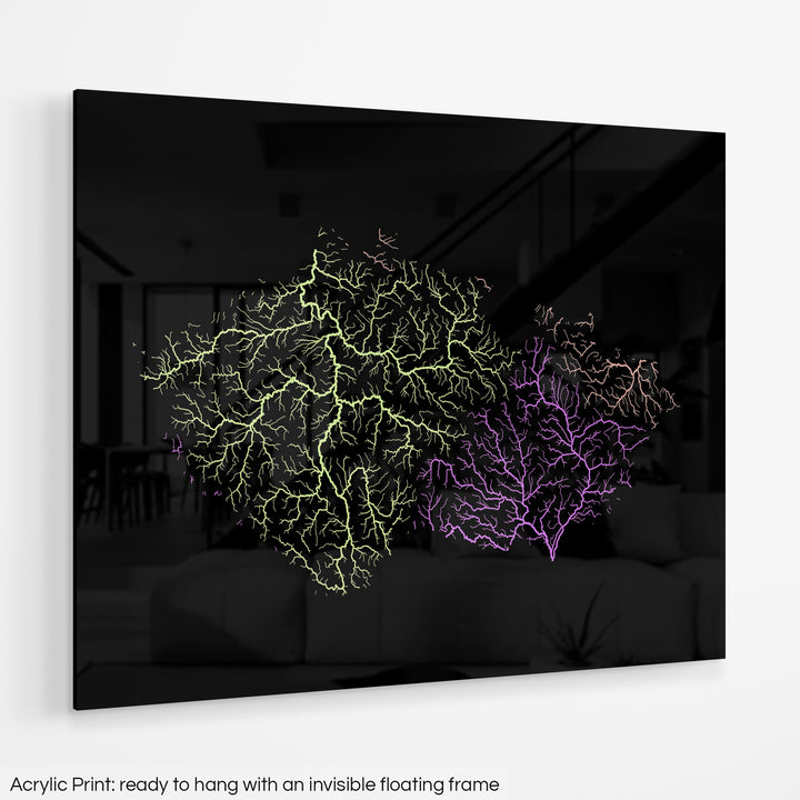 A colourful Grasshopper Geography map hanging on a white wall. The text at the bottom reads: Acrylic print - ready to hang with an invisible floating frame.