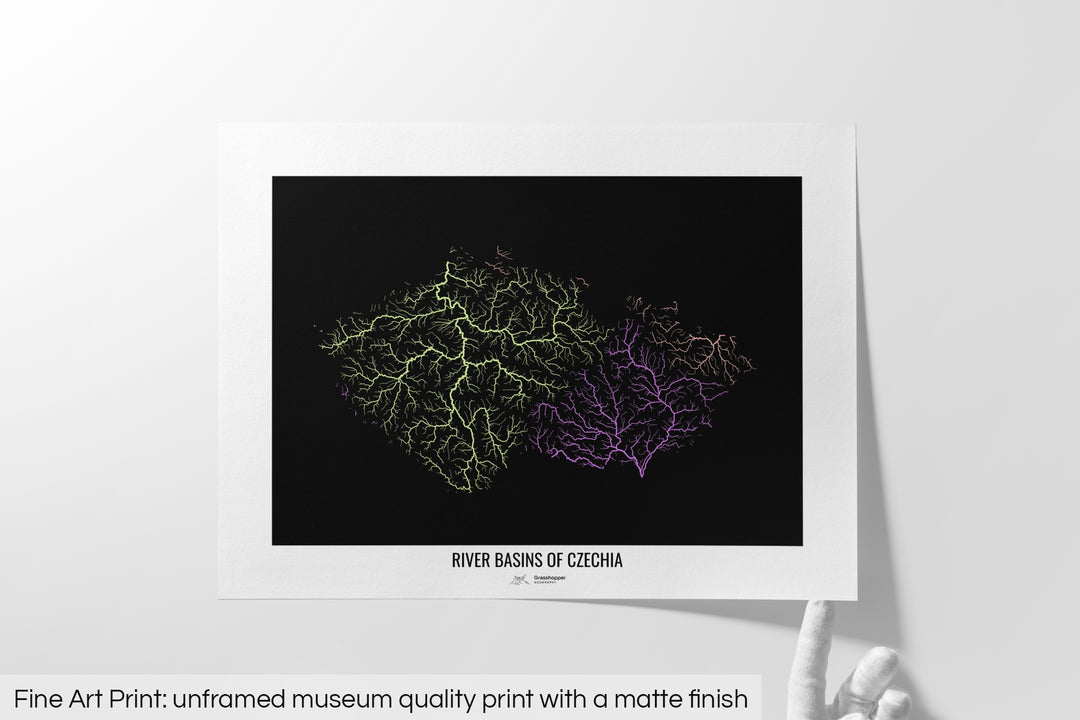 Unframed fine art print of a colourful map with a thick white mat. The title of the map and the Grasshopper Geography logo is printed on the mat, below the image. The map print lies flat on a white surface, a hand holding up one of the corners. The bottom text reads: Fine art print - unframed museum quality print with a matte finish.