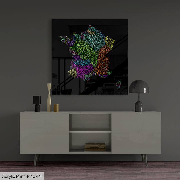 A colourful Grasshopper Geography map, home decor hanging on a grey wall in a living room. The map is printed on an acrylic panel and hangs above a modern low storage cabinet.