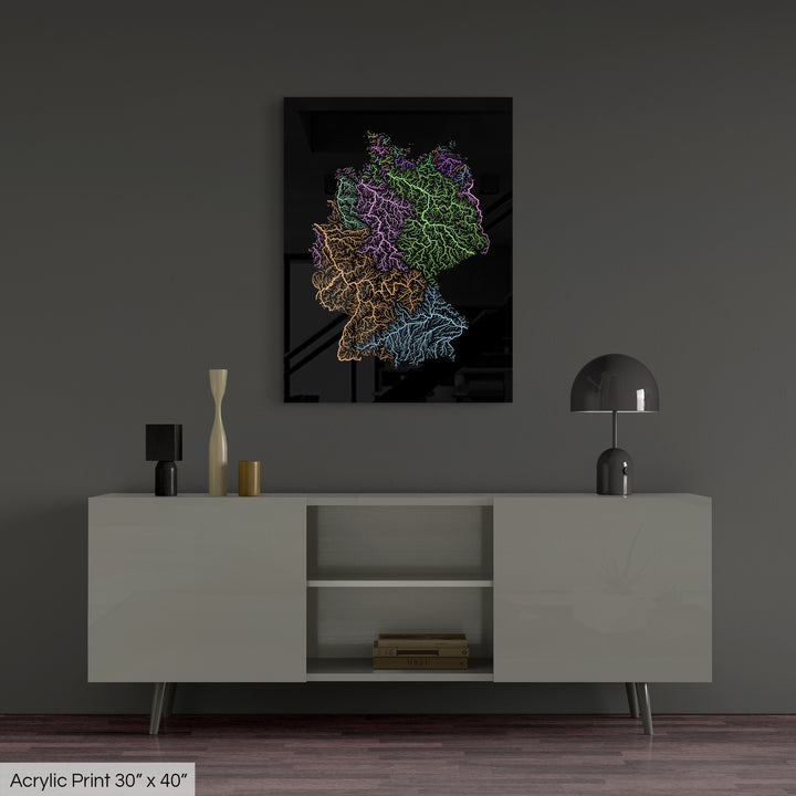 A colourful Grasshopper Geography map, home decor hanging on a grey wall in a living room. The map is printed on an acrylic panel and hangs above a modern low storage cabinet.