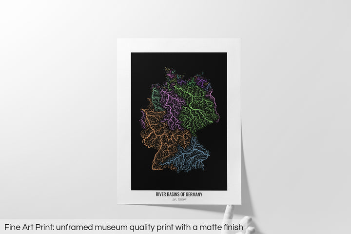 Unframed fine art print of a colourful map with a thick white mat. The title of the map and the Grasshopper Geography logo is printed on the mat, below the image. The map print lies flat on a white surface, a hand holding up one of the corners. The bottom text reads: Fine art print - unframed museum quality print with a matte finish.