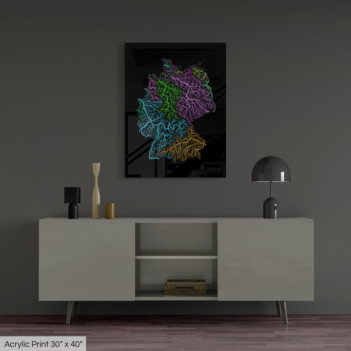 A colourful Grasshopper Geography map, home decor hanging on a grey wall in a living room. The map is printed on an acrylic panel and hangs above a modern low storage cabinet.