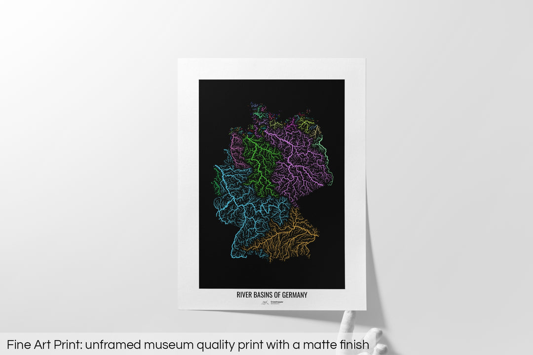 Unframed fine art print of a colourful map with a thick white mat. The title of the map and the Grasshopper Geography logo is printed on the mat, below the image. The map print lies flat on a white surface, a hand holding up one of the corners. The bottom text reads: Fine art print - unframed museum quality print with a matte finish.