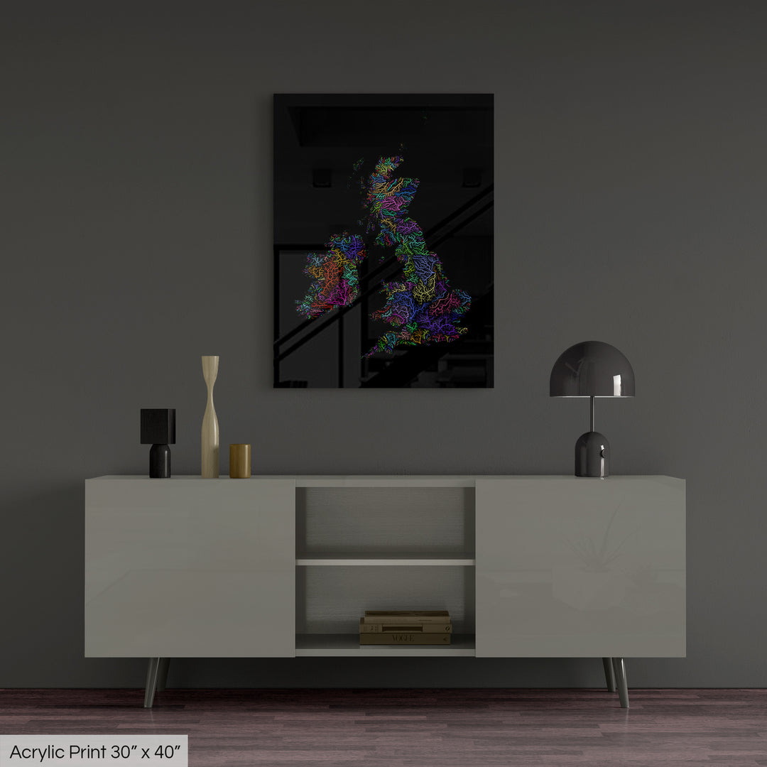 A colourful Grasshopper Geography map, home decor hanging on a grey wall in a living room. The map is printed on an acrylic panel and hangs above a modern low storage cabinet.