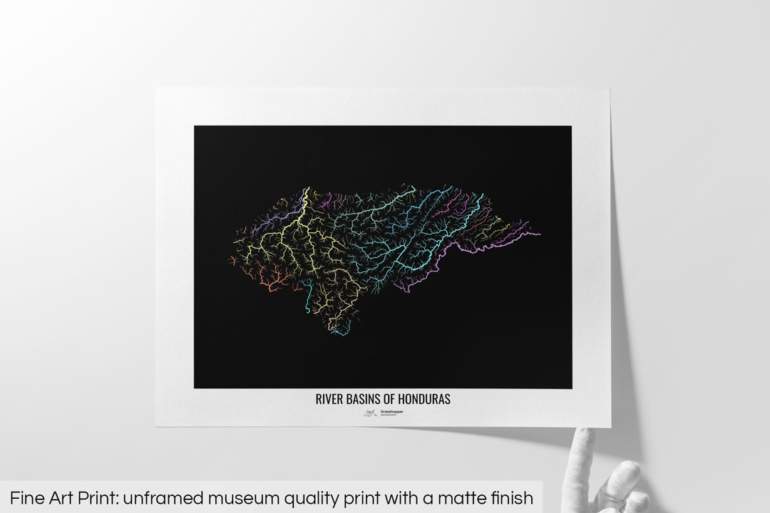 Unframed fine art print of a colourful map with a thick white mat. The title of the map and the Grasshopper Geography logo is printed on the mat, below the image. The map print lies flat on a white surface, a hand holding up one of the corners. The bottom text reads: Fine art print - unframed museum quality print with a matte finish.