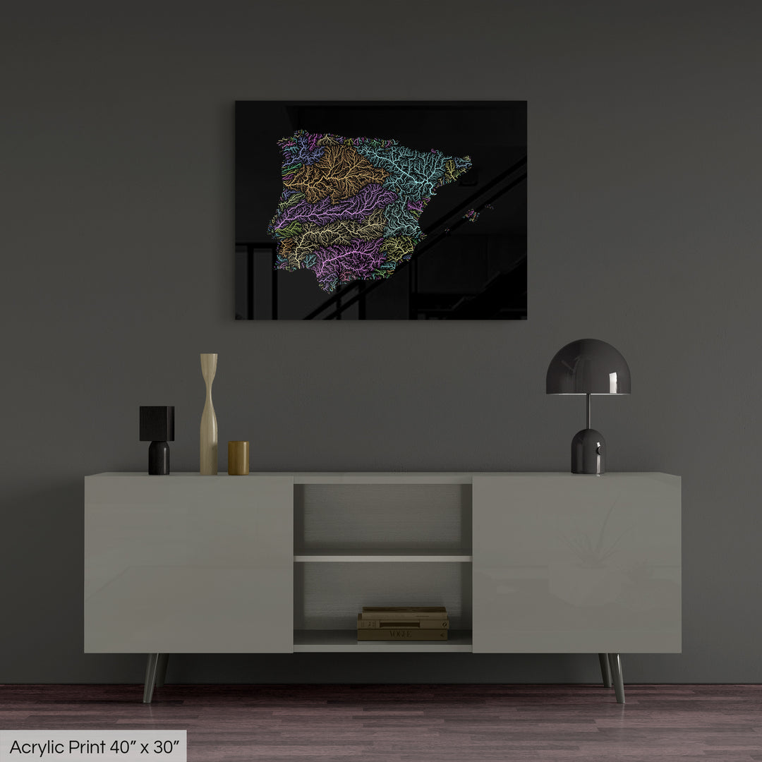 A colourful Grasshopper Geography map, home decor hanging on a grey wall in a living room. The map is printed on an acrylic panel and hangs above a modern low storage cabinet.