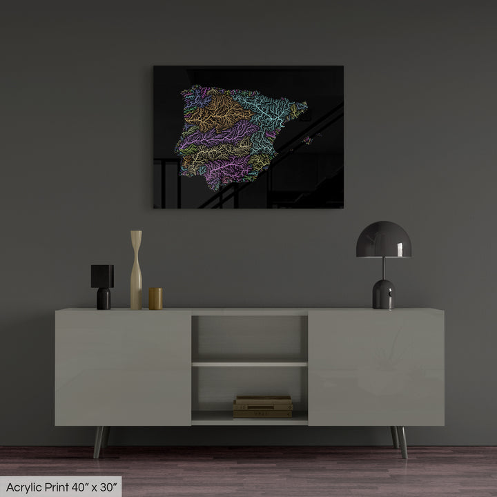 A colourful Grasshopper Geography map, home decor hanging on a grey wall in a living room. The map is printed on an acrylic panel and hangs above a modern low storage cabinet.