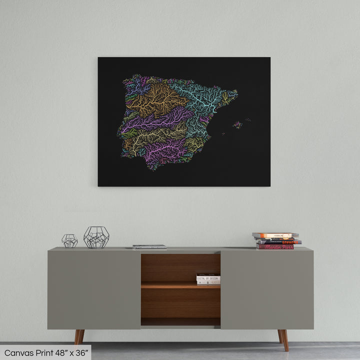 A colourful Grasshopper Geography map home decor in a living room, on a light grey wall. The map is printed on canvas and hangs above a modern low storage cabinet.