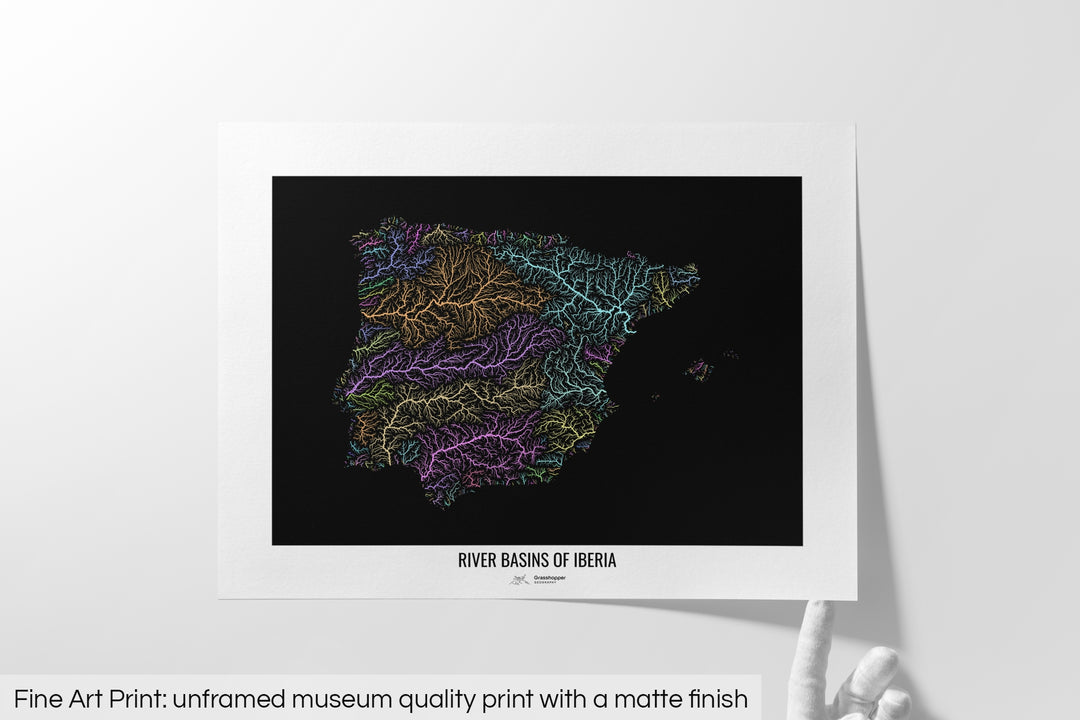 Unframed fine art print of a colourful map with a thick white mat. The title of the map and the Grasshopper Geography logo is printed on the mat, below the image. The map print lies flat on a white surface, a hand holding up one of the corners. The bottom text reads: Fine art print - unframed museum quality print with a matte finish.