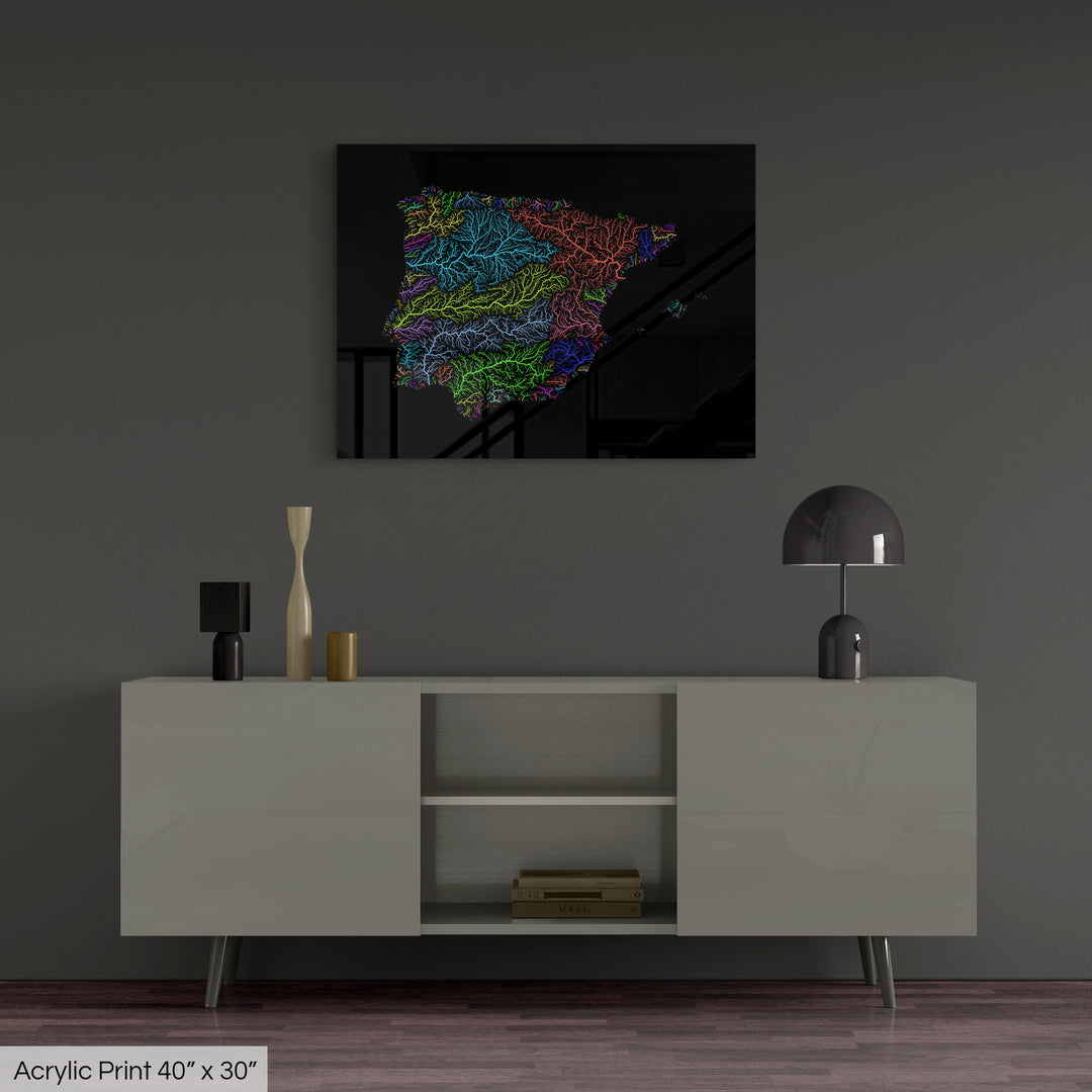 A colourful Grasshopper Geography map, home decor hanging on a grey wall in a living room. The map is printed on an acrylic panel and hangs above a modern low storage cabinet.