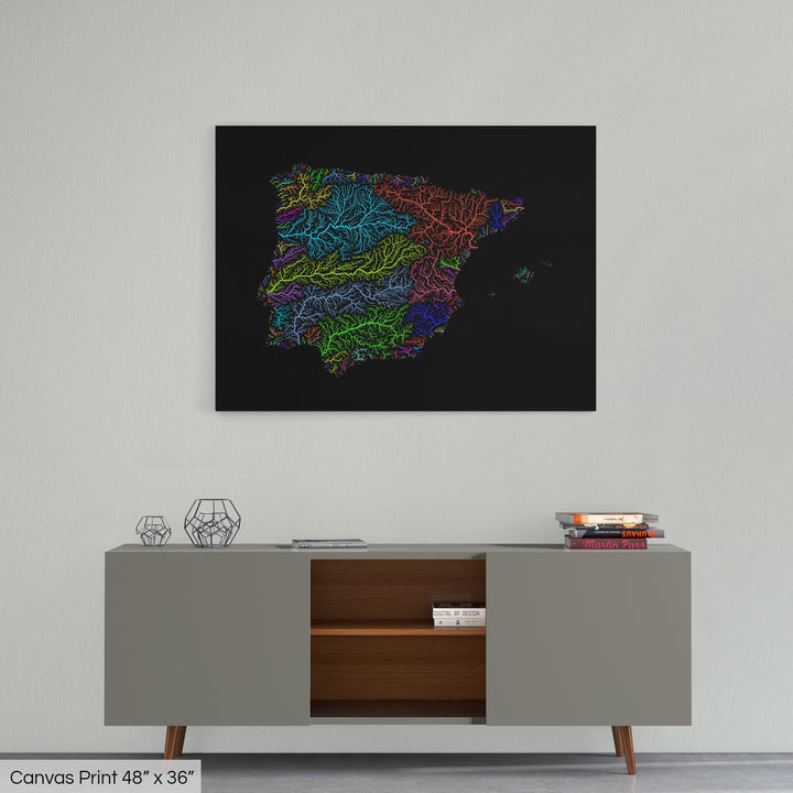 A colourful Grasshopper Geography map home decor in a living room, on a light grey wall. The map is printed on canvas and hangs above a modern low storage cabinet.
