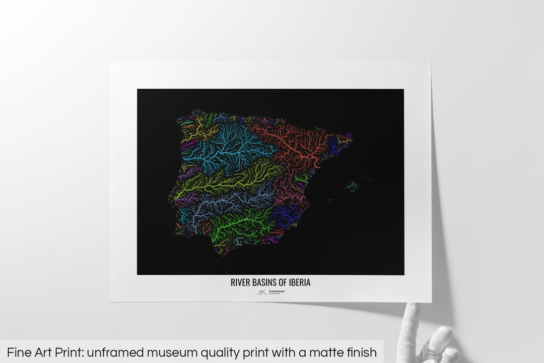 Unframed fine art print of a colourful map with a thick white mat. The title of the map and the Grasshopper Geography logo is printed on the mat, below the image. The map print lies flat on a white surface, a hand holding up one of the corners. The bottom text reads: Fine art print - unframed museum quality print with a matte finish.