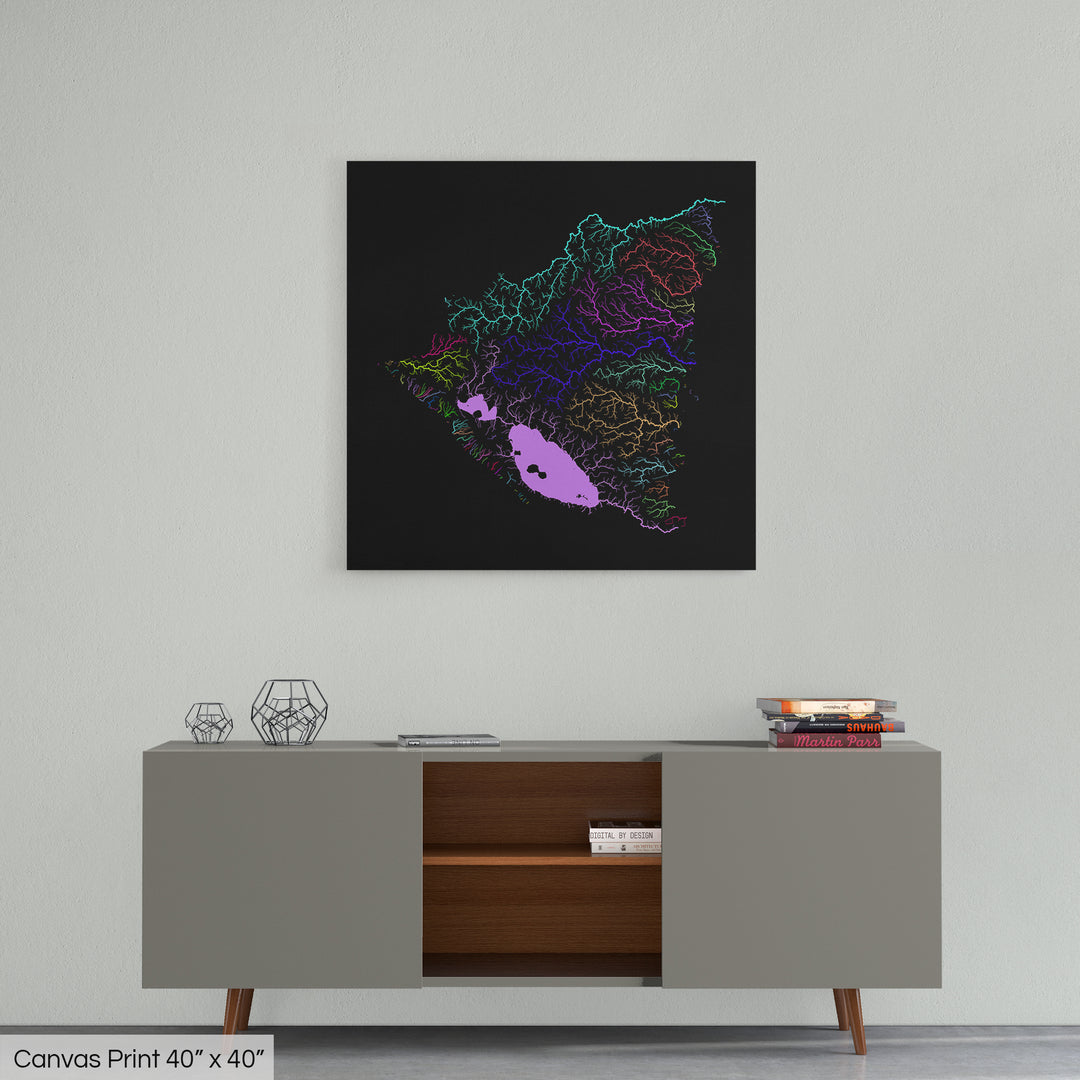 A colourful Grasshopper Geography map home decor in a living room, on a light grey wall. The map is printed on canvas and hangs above a modern low storage cabinet.