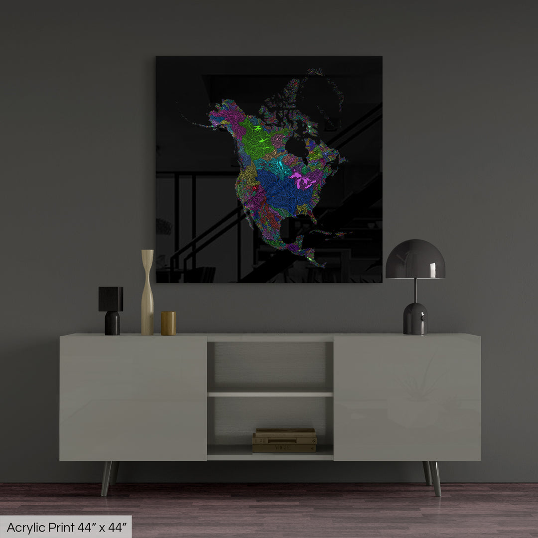 A colourful Grasshopper Geography map, home decor hanging on a grey wall in a living room. The map is printed on an acrylic panel and hangs above a modern low storage cabinet.