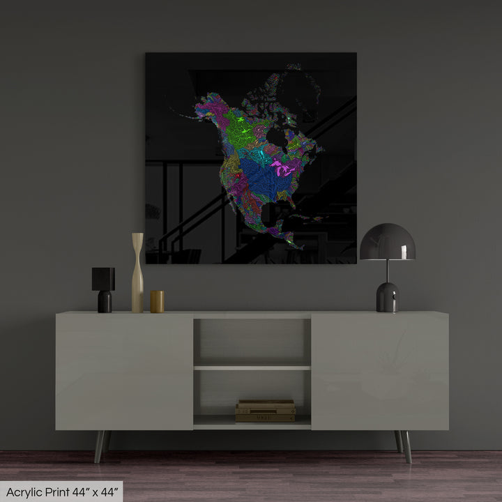 A colourful Grasshopper Geography map, home decor hanging on a grey wall in a living room. The map is printed on an acrylic panel and hangs above a modern low storage cabinet.