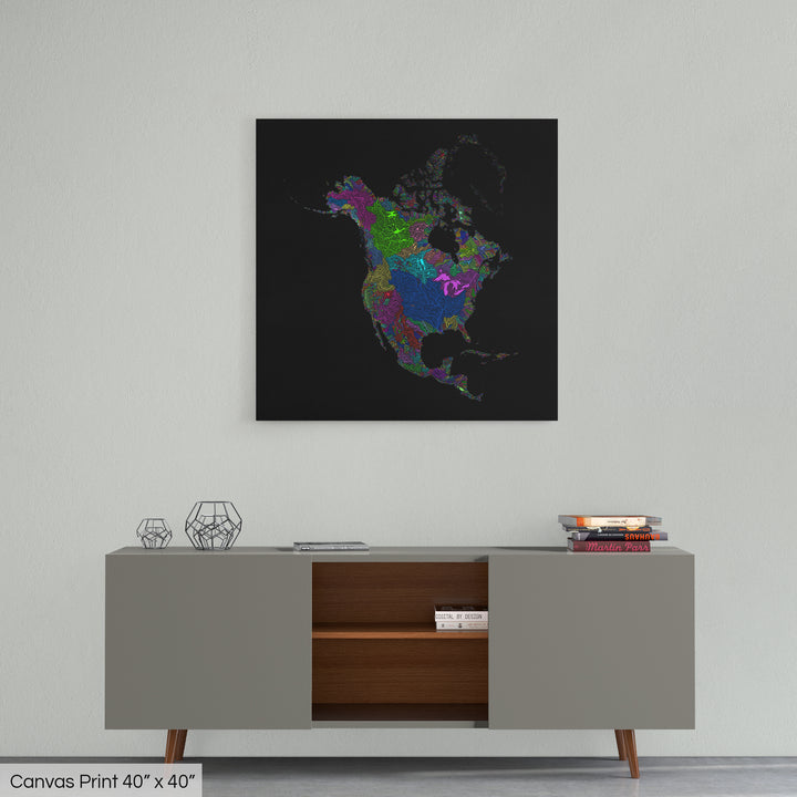 A colourful Grasshopper Geography map home decor in a living room, on a light grey wall. The map is printed on canvas and hangs above a modern low storage cabinet.