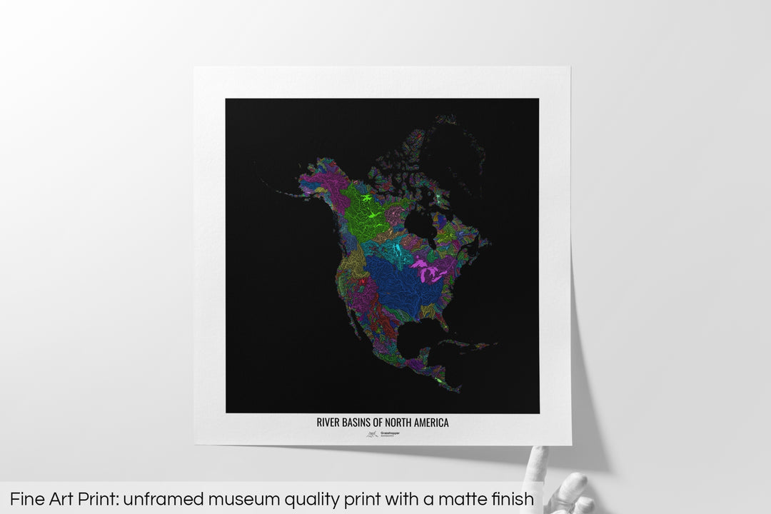 Unframed fine art print of a colourful map with a thick white mat. The title of the map and the Grasshopper Geography logo is printed on the mat, below the image. The map print lies flat on a white surface, a hand holding up one of the corners. The bottom text reads: Fine art print - unframed museum quality print with a matte finish.