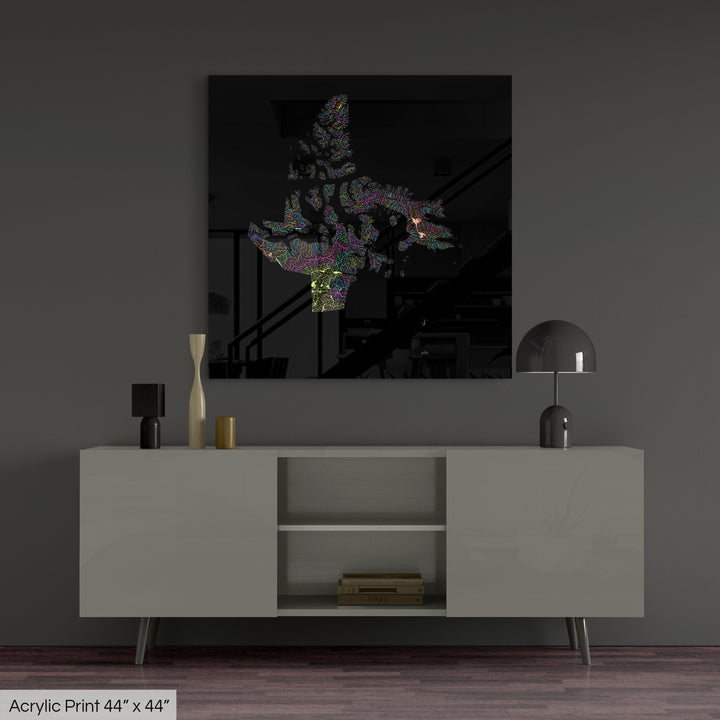 A colourful Grasshopper Geography map, home decor hanging on a grey wall in a living room. The map is printed on an acrylic panel and hangs above a modern low storage cabinet.