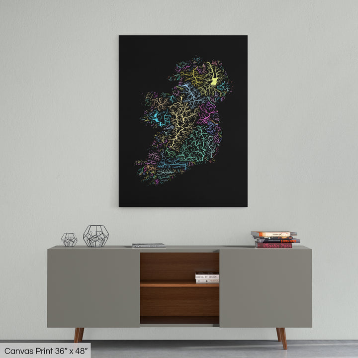 A colourful Grasshopper Geography map home decor in a living room, on a light grey wall. The map is printed on canvas and hangs above a modern low storage cabinet.