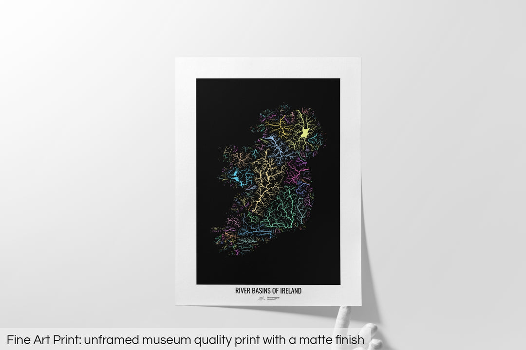 Unframed fine art print of a colourful map with a thick white mat. The title of the map and the Grasshopper Geography logo is printed on the mat, below the image. The map print lies flat on a white surface, a hand holding up one of the corners. The bottom text reads: Fine art print - unframed museum quality print with a matte finish.