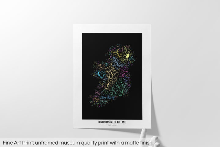 Unframed fine art print of a colourful map with a thick white mat. The title of the map and the Grasshopper Geography logo is printed on the mat, below the image. The map print lies flat on a white surface, a hand holding up one of the corners. The bottom text reads: Fine art print - unframed museum quality print with a matte finish.