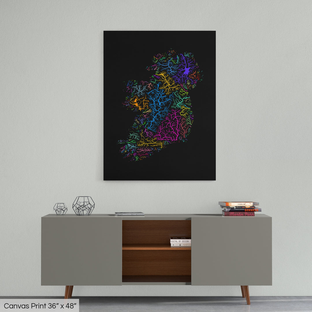 A colourful Grasshopper Geography map home decor in a living room, on a light grey wall. The map is printed on canvas and hangs above a modern low storage cabinet.